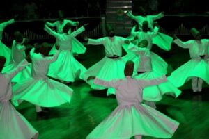 Cappadocia Whirling Dervish Show with Hotel Pick up and Drop off - Dervis Evi: watching the dance in a rock-cut cave setting